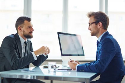 Business professionals collaborate during a meeting, supporting development of VET accredited courses.