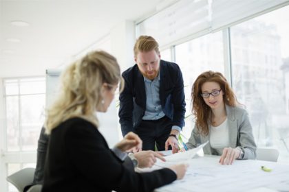 Business professionals review architectural plans, highlighting changes to the Australian Qualifications Framework.