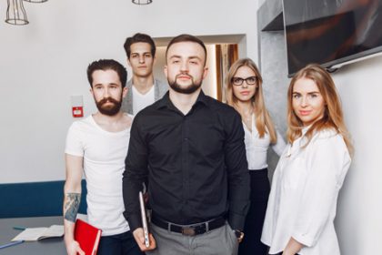 Young professionals collaborate in an office, highlighting positive experiences in the vet sector.