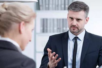 A professional conducts a job interview, highlighting the importance of assessment in VET.