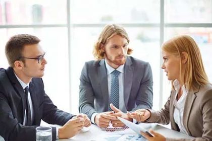 Business professionals analyze data during a team meeting, highlighting the importance of learner validation in the vet.