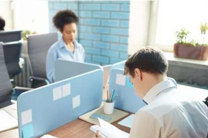 Office workers collaborate in a modern workspace, focusing on vet compliance.