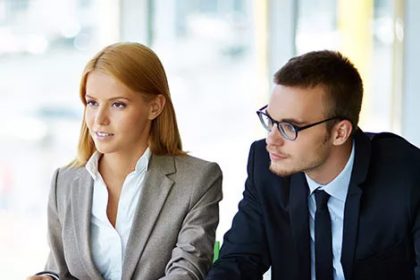 Business professionals discuss vet compliance during a meeting.