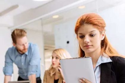 Business professionals collaborate in a modern office, highlighting the importance of teamwork in the vet sector.