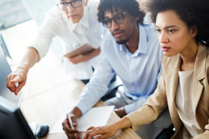 Teamwork in an office setting highlights the importance of vet compliance.
