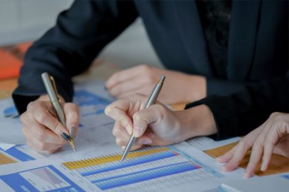 A team collaborates on data analysis, relevant to vet compliance and ASQA audit reports.