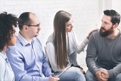 Adults participate in a support group, highlighting the importance of practical experience in Individual Support training.