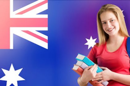 A young woman studies with books as the Australian flag waves, relating to changes in VET registration.