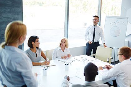 A team discusses training resources during a business meeting, highlighting the benefits of resource validation.