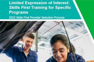 Students practice automotive skills in a vocational training workshop, highlighting the Skills First program.