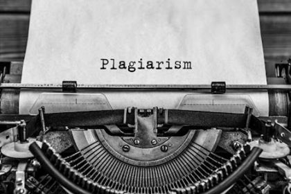 A vintage typewriter shows the word 'plagiarism', relevant to discussions around **vet compliance**.