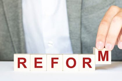A hand builds the word 'reform' with letter blocks, representing VET qualifications reform.