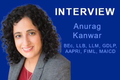 Anurag Kanwar, a professional in the vet sector, poses for a headshot with her qualifications.
