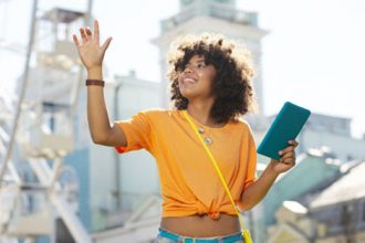 A woman uses a tablet at an amusement park, demonstrating how direct observations can apply to online learning environments.