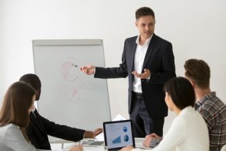 A team collaborates during a presentation, highlighting the importance of current industry knowledge in VET.