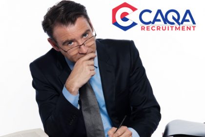 A professional reviews documents, representing the compliance role at CAQA.