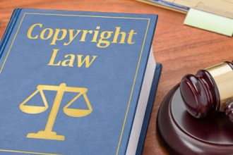 A law book and gavel illustrate copyright law and legal protection for VET resources.