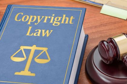 A law book and gavel illustrate copyright law and legal protection for VET resources.