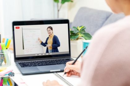 A student engages in online learning with a laptop, showcasing the benefits of vet sector courses.