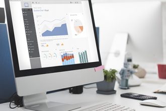 A computer screen displays vet data visualization, showing how to report AVETMISS data.