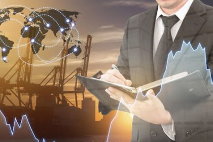 A businessman reviews financial data and logistics, highlighting the need for current VET training.