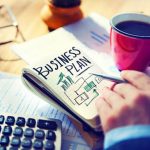 A hand reviews a business plan, essential for successful RTO training.