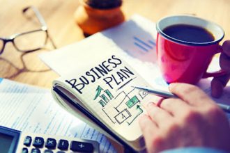 A hand reviews a business plan, essential for successful RTO training.