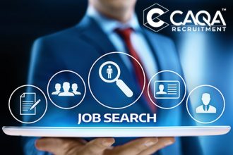 A business professional uses a tablet for a job search with CAQA recruitment services.