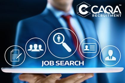 A business professional uses a tablet for a job search with CAQA recruitment services.