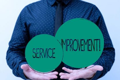 A presenter highlights service improvement concepts during a business presentation, focusing on RTO training.