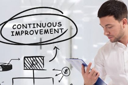 A man reviews planning documents illustrating continuous improvement for RTO training.