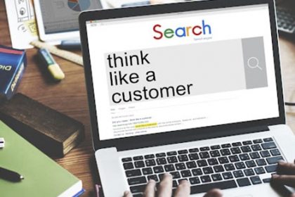 A laptop screen shows a search for 'think like a customer', highlighting the importance of customer experience in the vet.