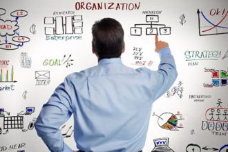 A businessman reviews a business strategy flowchart, highlighting challenges for RTO training.