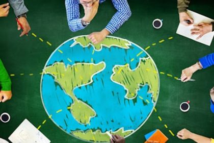 A team brainstorms global education strategies using a world map, reflecting international education.