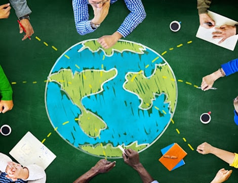 A team brainstorms global education strategies using a world map, reflecting international education.