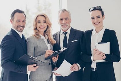 A business team collaborates on vet compliance documents and digital tablets.