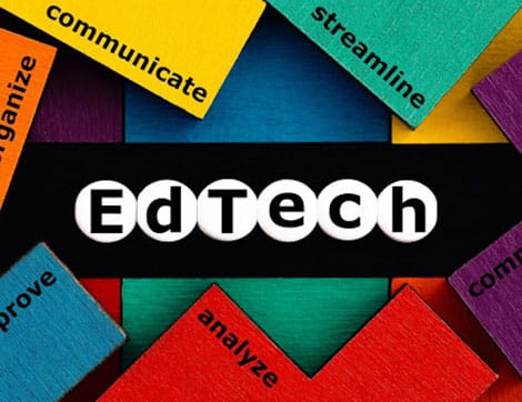 Colorful wooden blocks spell 'EdTech' representing innovation in the vet sector.