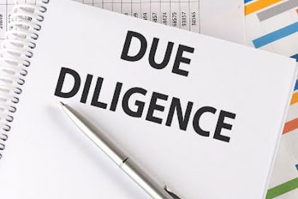 Due diligence paperwork and a pen represent the process of vet compliance.